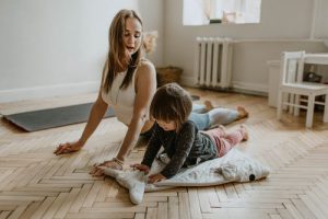 A woman and young boy doing upward facing dog together