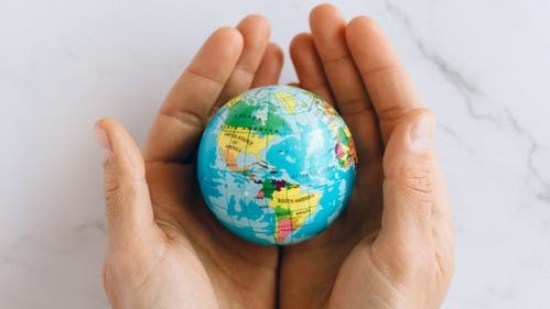 hands holding the a globe of the world
